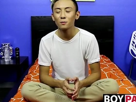 A young Asian man undresses and pleases himself after an interview.